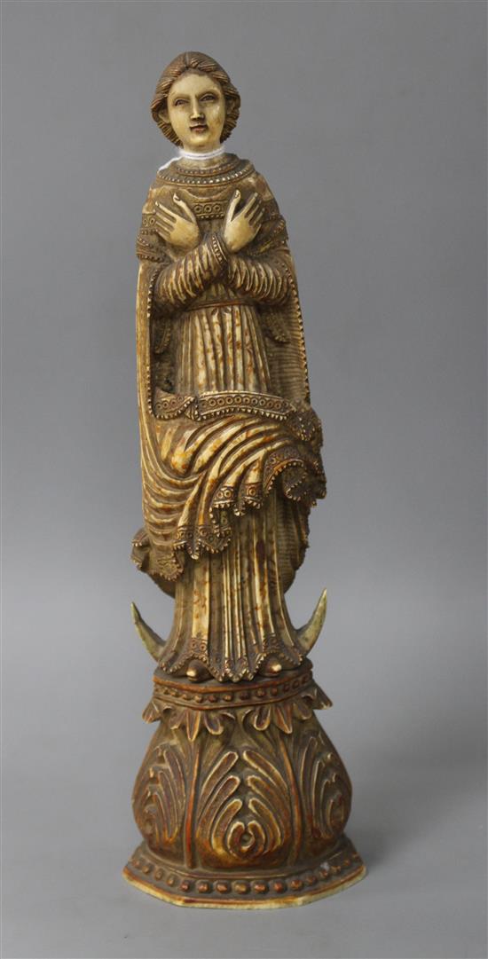 A 17th / 18th century Indo Portuguese carved and stained ivory figure of a saint, height 26cm